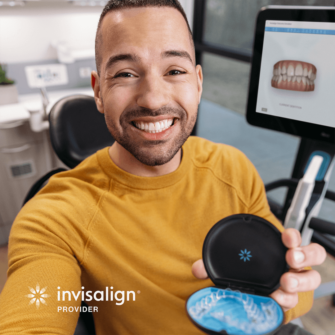 Invisalign patient smiling with clear aligners
